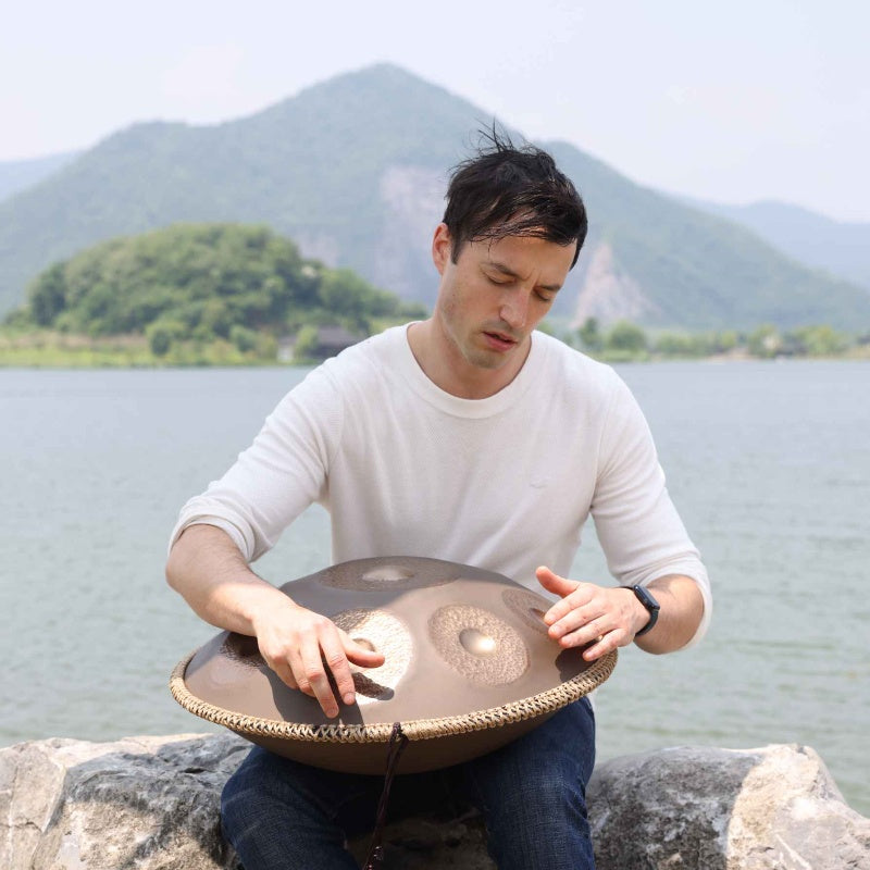 A beginner exploring the art of playing a handpan.