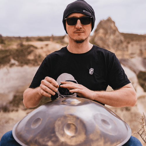 Enthusiastic handpan player delivering a soulful performance outdoors, using a premium handpan instrument.