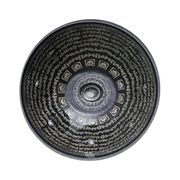 Tibetan text engraved on a handcrafted handpan