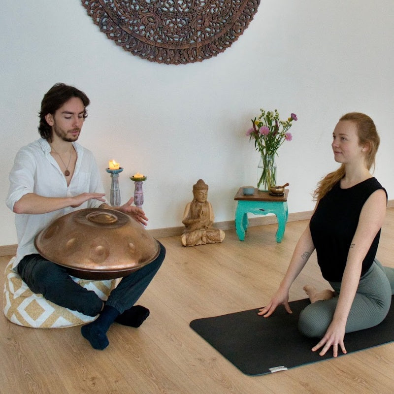 Girls practicing yoga while listening to handpan music