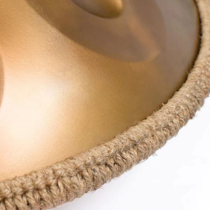 Detailed shot of a golden handpan drum, highlighting the craftsmanship and design.