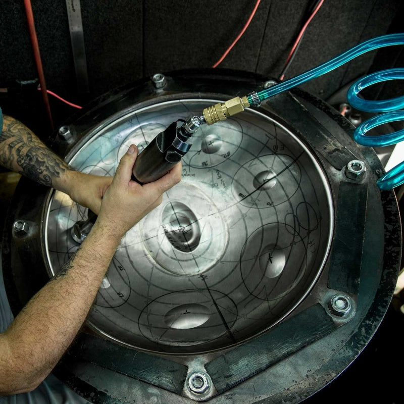 Precision tuning in progress for a handpan drum to ensure perfect sound quality