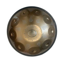 Gold handpan with intricate floral pattern and metallic finish