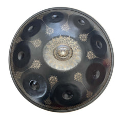 Black handpan featuring floral-inspired pattern