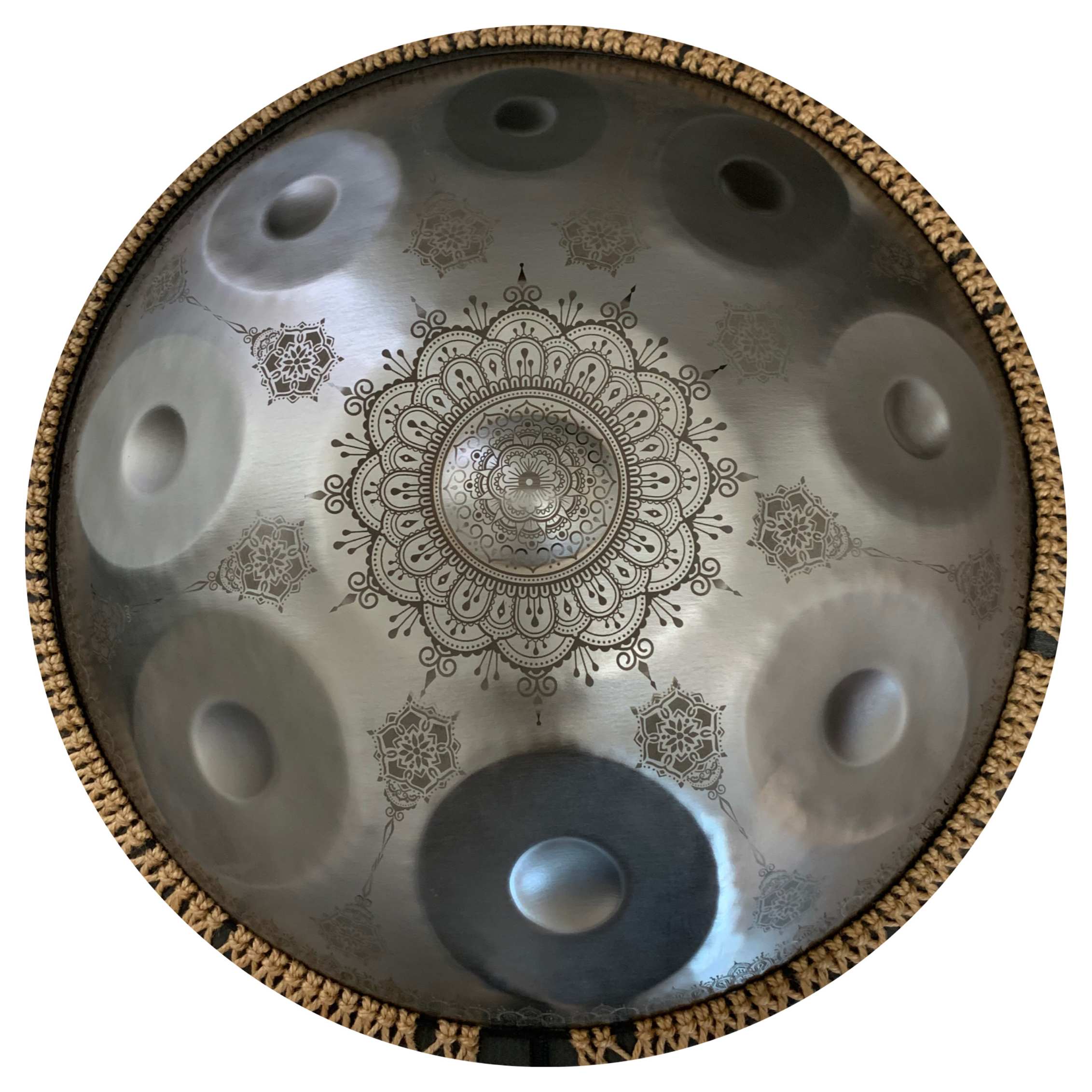 Silver handpan with delicate floral etchings and shimmering tones