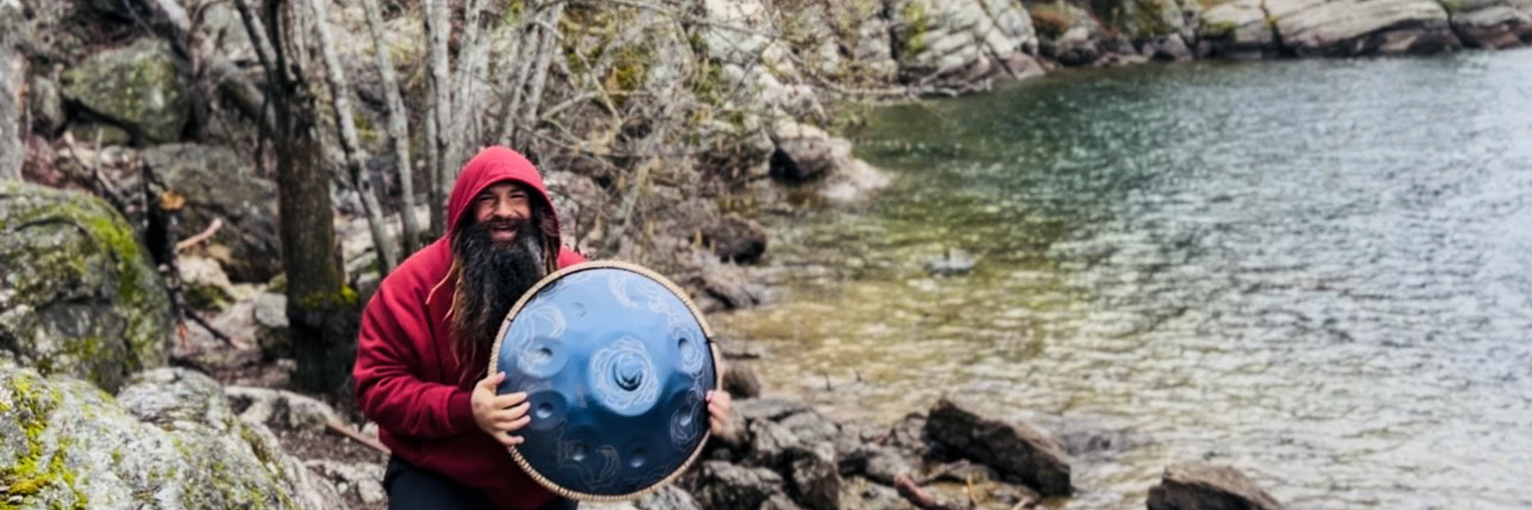 Musicians creating music with handpans by the lake.